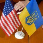 USA and Ukraine flags on meeting table.