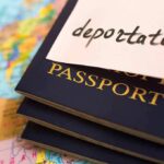 Passports stacked with deportation note on top.