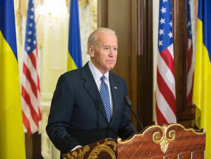 348383924 featured image Man speaking at podium with flags in background.