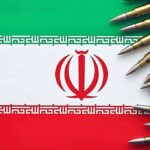 Iranian flag with bullets surrounding it.