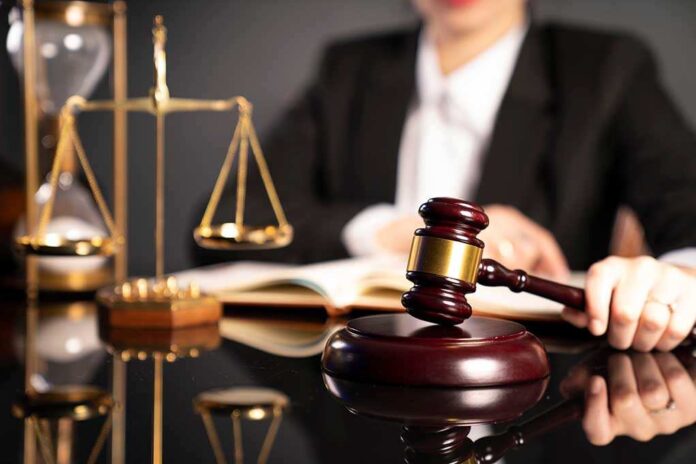 1585724791 featured image Judge with gavel, scales, and open book.