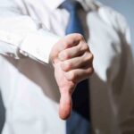 Internal Struggles and Waning Support: What’s Next for the Democrats? Person giving a thumbs down gesture.