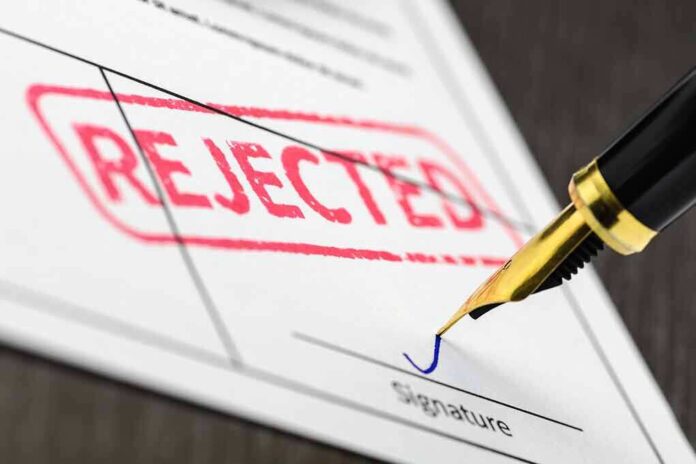 645114751 featured image Rejected stamp on a document with pen.