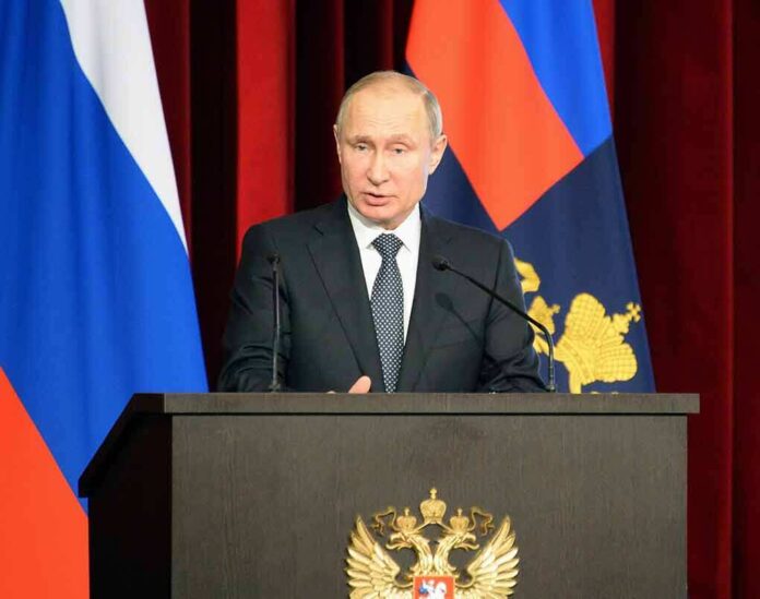 1038561886 featured image Man speaking at a podium with flags behind him