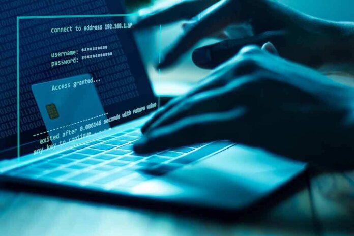 1107463670 featured image Hands typing on laptop with security overlay display