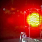Flashing red warning light with blurred background.