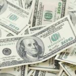 Pile of US hundred dollar bills