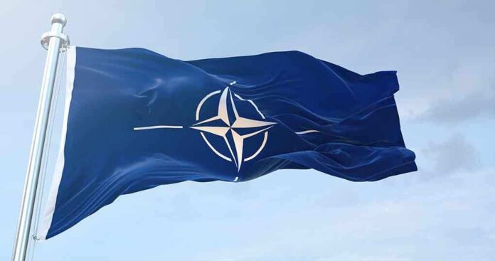 1633919905 featured image NATO flag waving against blue sky.