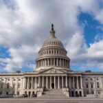 Capitol building under a cloudy blue sky