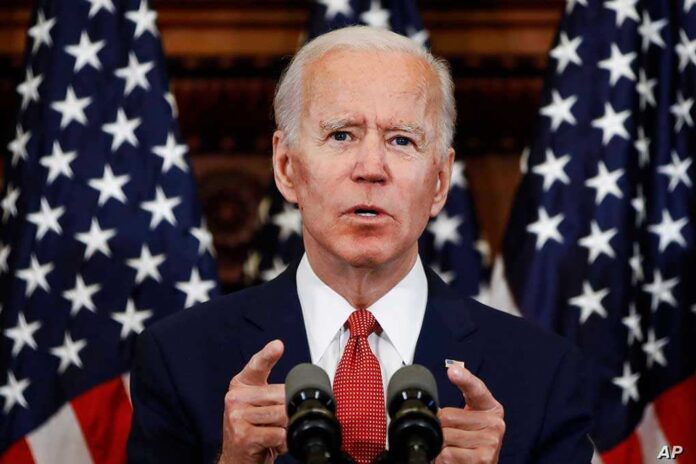 1836802909 featured image Man speaking at podium with American flags behind