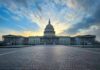 Capitol building under dramatic sky at sunset or sunrise
