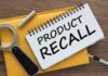 Notebook with product recall text magnifying glass pen