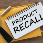Notebook with product recall text magnifying glass pen