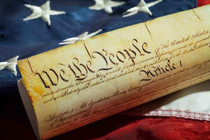 290018204 featured image US Constitution on American flag background.