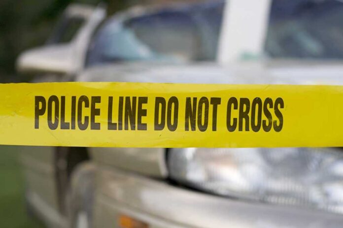 3358598 featured image Yellow police tape in front of a car.