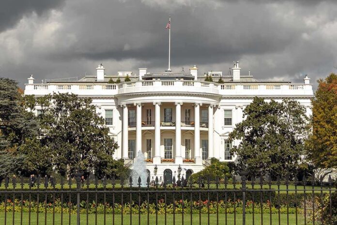560339335 featured image The White House with overcast sky and flag raised.