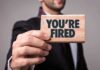 Man holding Youre Fired sign card