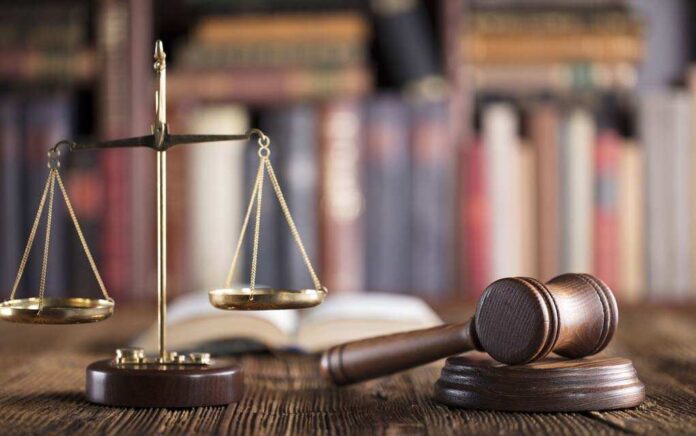 666508099 featured image Gavel and scales on desk with books.