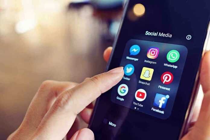 1064490605 featured image Finger tapping social media app icons on a smartphone.