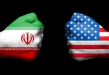 Two fists with Iran and USA flags oppose