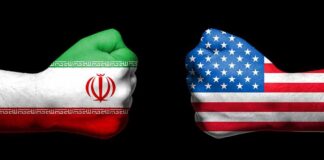 Two fists with Iran and USA flags oppose