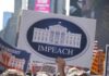 Protesters hold signs calling for impeachment