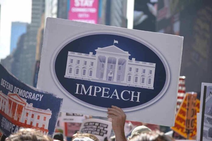 1529910779 featured image Protesters hold signs calling for impeachment