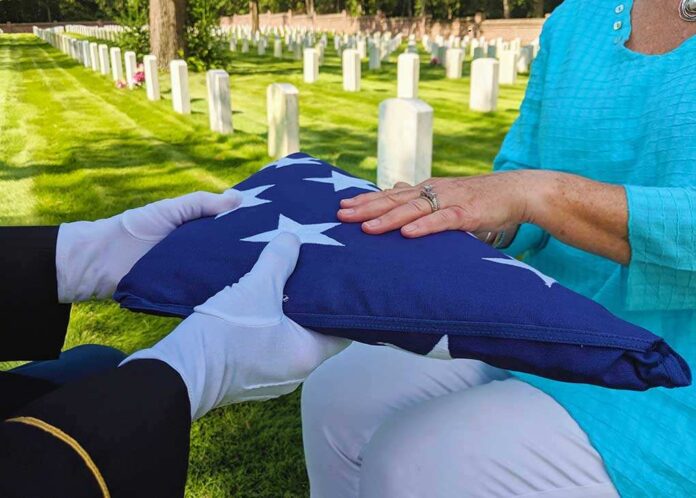 Flag folded and handed over at gravesite ceremony