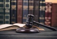 Gavel and open book in library setting
