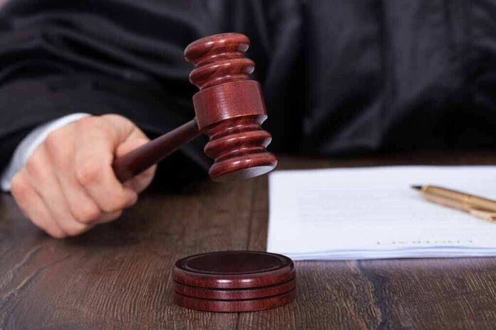 186812807 featured image Judges hand holding a gavel near documents