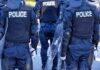 Police officers in riot gear with shields