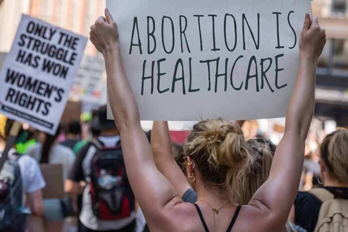 2172202723 featured image Protestors holding signs about women's rights and healthcare.