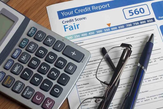243901528 featured image Calculator and glasses on credit report document