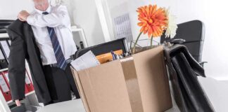 Cardboard box with office items and flowers