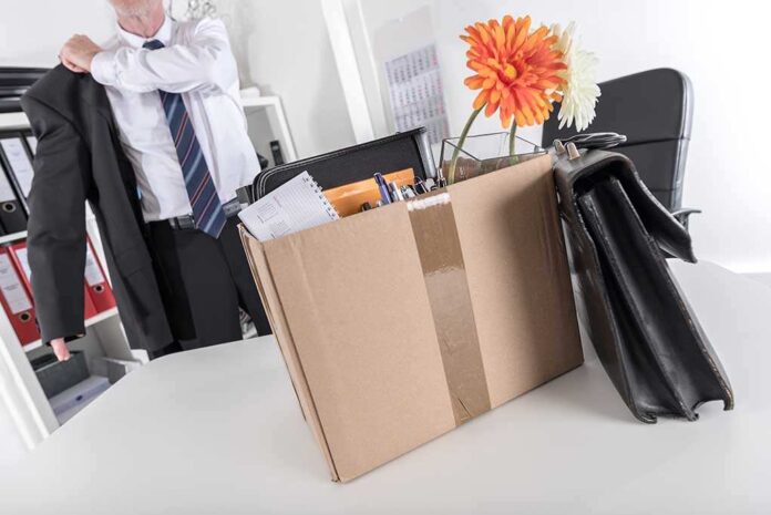 325505735 featured image Cardboard box with office items and flowers
