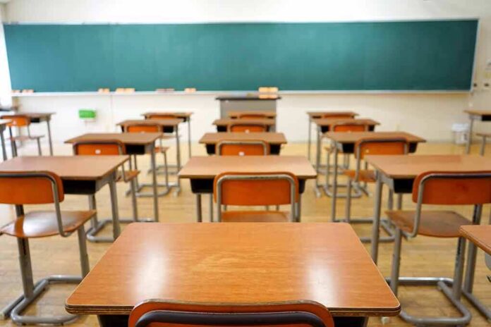 356921618 featured image Classroom with wooden desks and empty green chalkboard