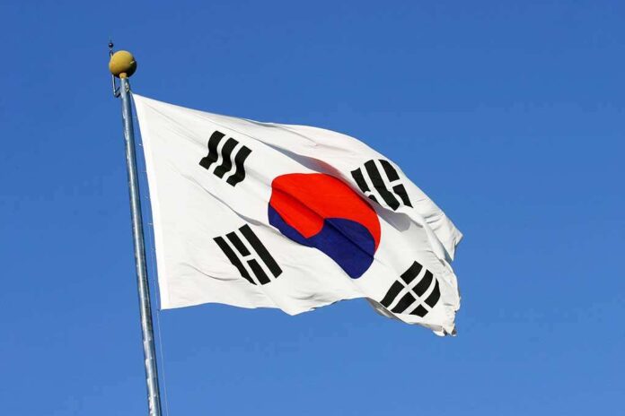 46451284 featured image South Korean flag waving against clear blue sky.