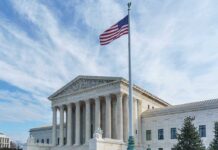 Supreme Court building with American flag flying.