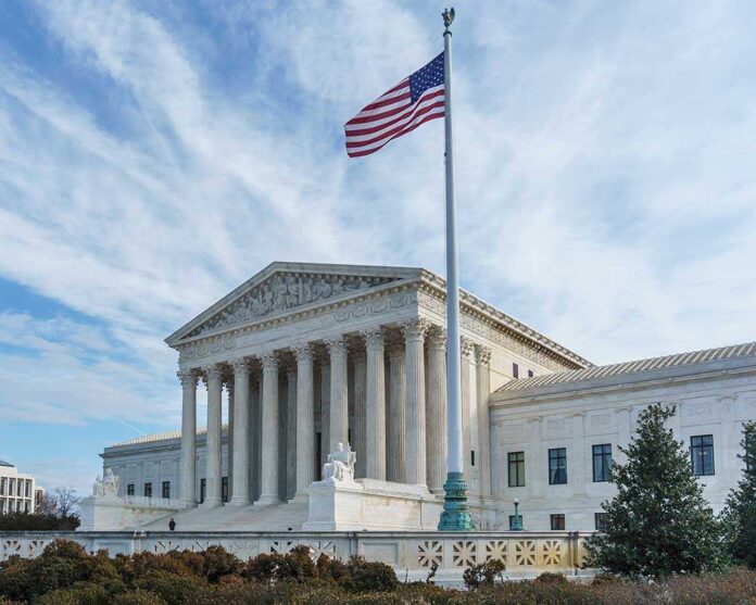 568824388 featured image Supreme Court building with American flag flying.