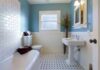 Modern bathroom with blue walls and white fixtures.