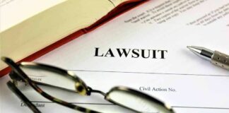 Lawsuit document with pen glasses and open book