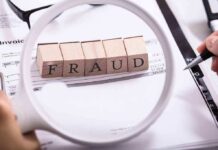 Fraud blocks under magnifying glass on invoices