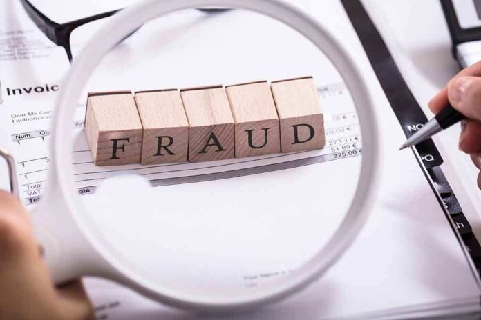 Fraud blocks under magnifying glass on invoices