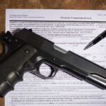 Gun and pen on firearm transaction form