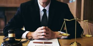 Person in suit with gavel and scales of justice