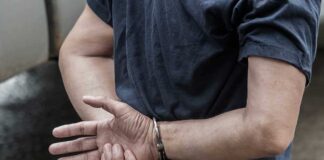 Person in handcuffs with hands behind back