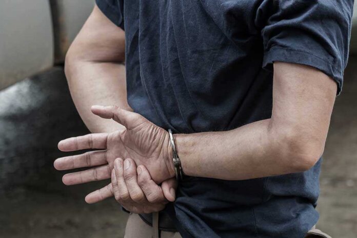 1115333126 featured image Person in handcuffs with hands behind back