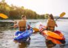 Two people kayaking on a sunny river