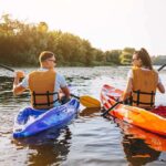 Two people kayaking on a sunny river