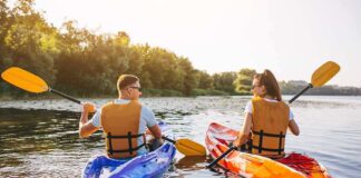 Two people kayaking on a sunny river